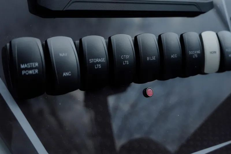 Slide: The Image of Control panel of 2025 SunCatcher Fusion 324RCX with labeled switches and buttons. - 15