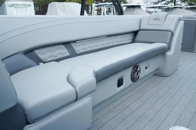 Slide: The Image of 2025 SunCatcher Fusion 324RCX boat interior with sleek gray seating and modern design. - 20