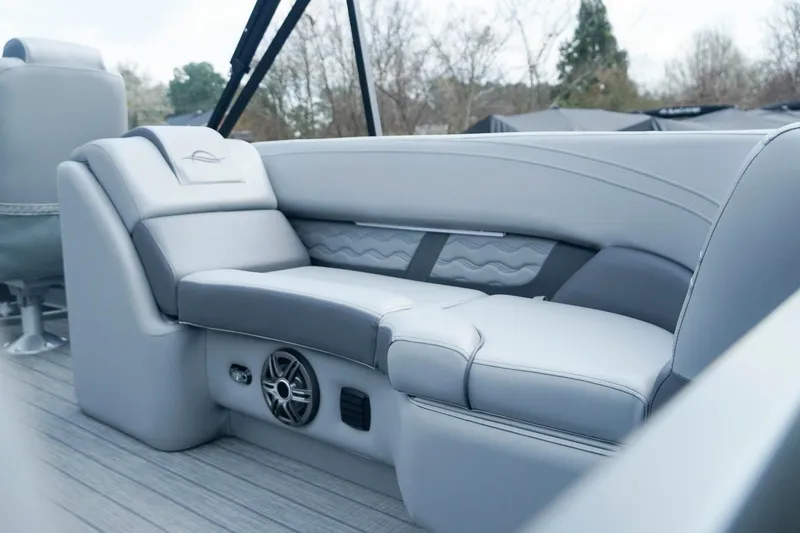 Slide: The Image of Luxurious seating on 2025 SunCatcher Fusion 324RCX boat, featuring sleek design and integrated speaker. - 21