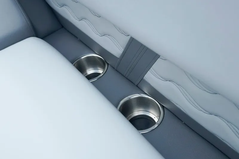 Slide: The Image of 2025 SunCatcher Fusion 324RCX interior with dual stainless steel cup holders. - 25