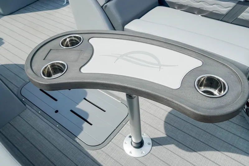 Slide: The Image of 2025 SunCatcher Fusion 324RCX boat table with cup holders on a sleek deck. - 28