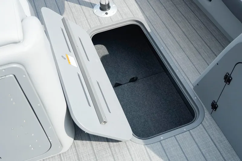 Slide: The Image of Open storage compartment on 2025 SunCatcher Fusion 324RCX boat deck. - 32
