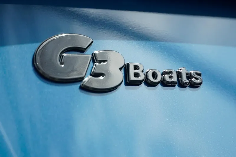 Slide: The Image of Chrome "G3 Boats" logo on blue SunCatcher Fusion 324RCX, 2025 model. - 38