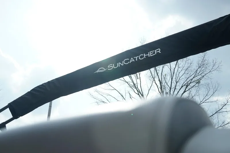 Slide: The Image of SunCatcher Fusion 324RCX 2025 boat canopy against a bright sky background. - 6