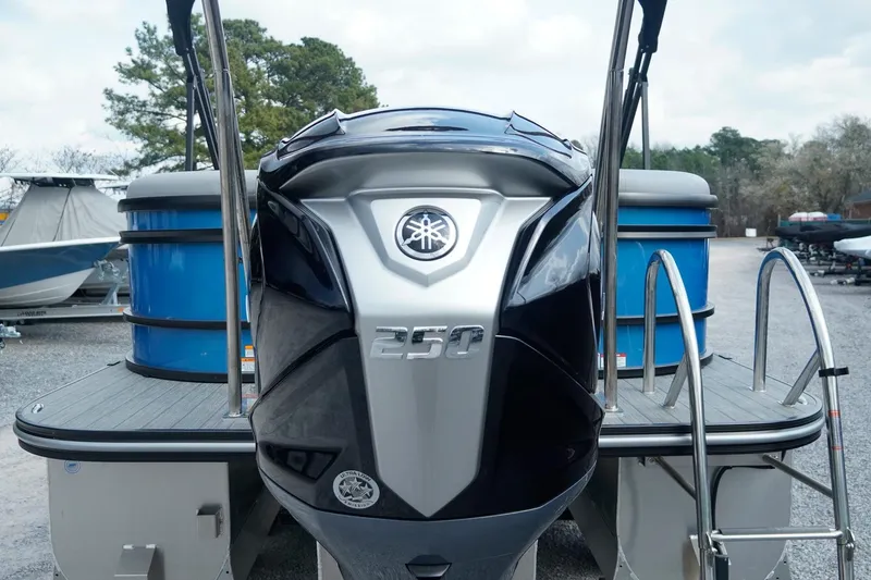 Slide: The Image of 2025 SunCatcher Fusion 324RCX boat with Yamaha 250 engine, docked outdoors. - 8