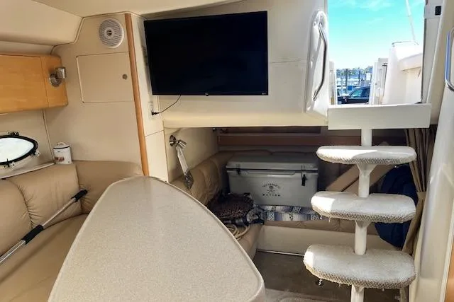 Slide: The Image of Interior of 2004 Larson 330 boat with TV, seating, and stairs. - 5