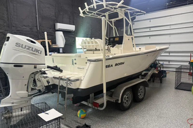 The Image of 2021 Seaborn LX22 boat with Suzuki engine in a garage setting. - 0