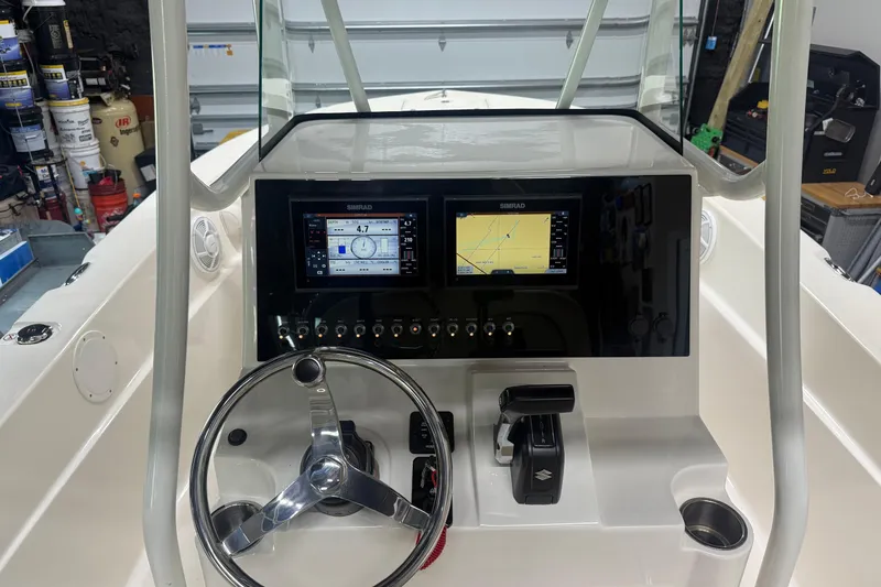 Slide: The Image of 2021 Seaborn LX22 boat dashboard with dual Simrad displays and steering wheel. - 10