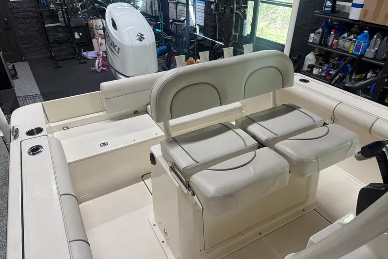 Slide: The Image of Interior of 2021 Seaborn LX22 boat with seating and Suzuki outboard motor. - 13