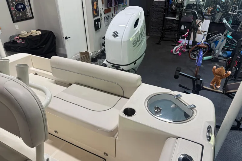 Slide: The Image of 2021 Seaborn LX22 boat interior with Suzuki engine in a garage setting. - 14