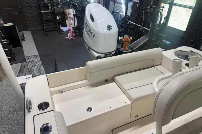 Slide: The Image of 2021 Seaborn LX22 boat interior with Suzuki engine in a garage setting. - 15
