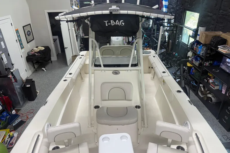 Slide: The Image of 2021 Seaborn LX22 boat in a garage, featuring spacious seating and storage. - 3