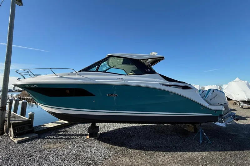 Slide: The Image of 2021 Sea Ray Sundancer 320 Coupe Outboard on display at a marina. - 3