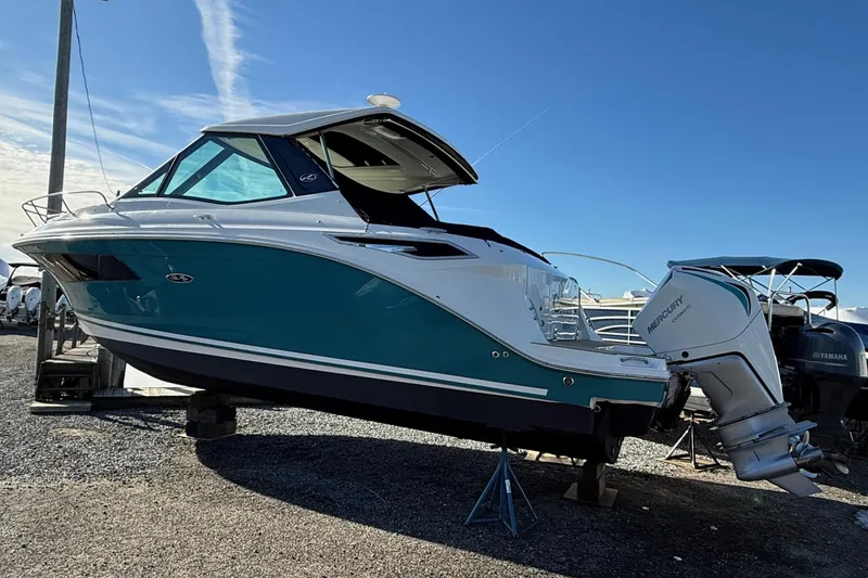 Slide: The Image of 2021 Sea Ray Sundancer 320 Coupe Outboard on display, featuring sleek design and powerful Mercury engine. - 4