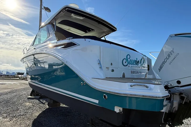 Slide: The Image of 2021 Sea Ray Sundancer 320 Coupe Outboard in sunlight, featuring sleek design and Mercury Verado engines. - 5