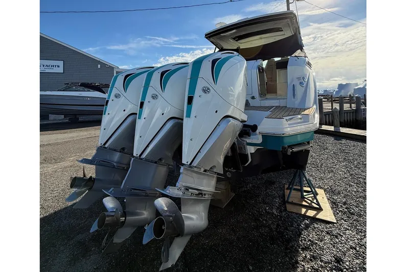 Slide: The Image of 2021 Sea Ray Sundancer 320 Coupe Outboard with triple engines, docked under a clear sky. - 7