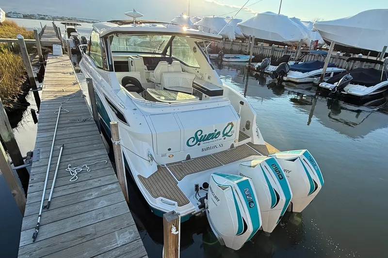 Slide: The Image of 2021 Sea Ray Sundancer 320 Coupe Outboard docked at marina, rear view. - 8