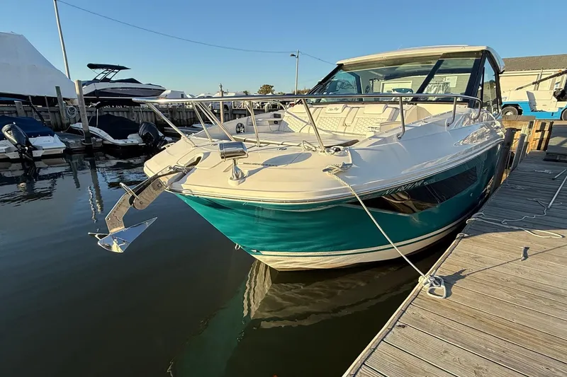 Slide: The Image of 2021 Sea Ray Sundancer 320 Coupe Outboard docked at marina, sunny day. - 9
