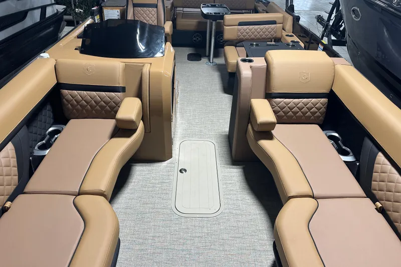Slide: The Image of Luxurious 2026 Godfrey AquaPatio 255 DFL boat interior with illuminated dashboard and plush seating. - 12