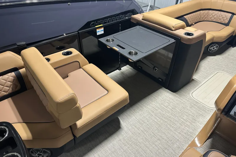 Slide: The Image of Luxurious interior of 2026 Godfrey AquaPatio 255 DFL pontoon boat with tan seating and table. - 15