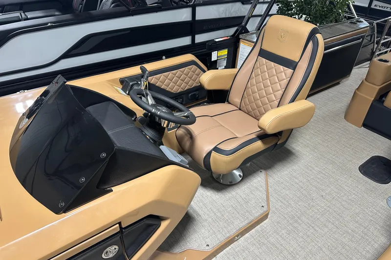 Slide: The Image of 2026 Godfrey AquaPatio 255 DFL boat interior with tan quilted seating and cup holders. - 16