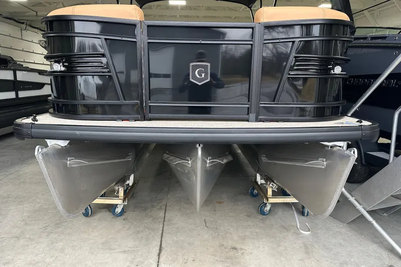 Slide: The Image of 2026 Godfrey AquaPatio 255 DFL pontoon boat with powerful outboard motor in showroom. - 27