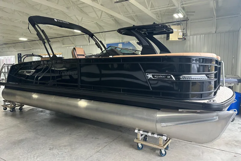 Slide: The Image of 2026 Godfrey AquaPatio 255 DFL pontoon boat in a showroom setting. - 4
