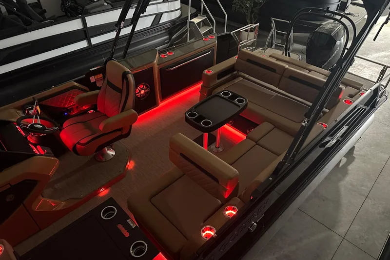 Slide: The Image of 2026 Godfrey AquaPatio 255 DFL pontoon boat in a showroom, showcasing sleek design. - 5