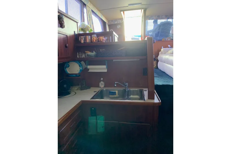 Slide: The Image of 1985 Chris-Craft 426 Catalina yacht deck with covered seating and life preserver. - 11