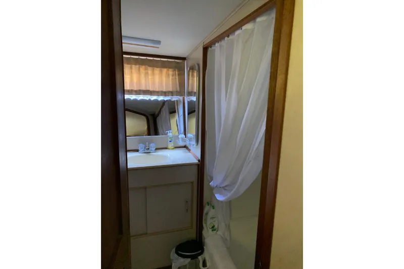 Slide: The Image of 1985 Chris-Craft 426 Catalina yacht interior with wood paneling and steering wheel. - 14