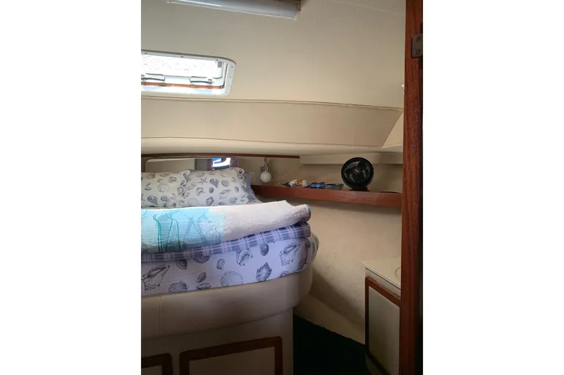 Slide: The Image of 1985 Chris-Craft 426 Catalina interior with kitchen, dining area, and wood accents. - 15
