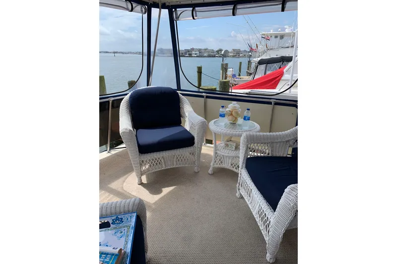 Slide: The Image of Interior of 1985 Chris-Craft 426 Catalina yacht with wood cabinetry and blue blinds. - 18
