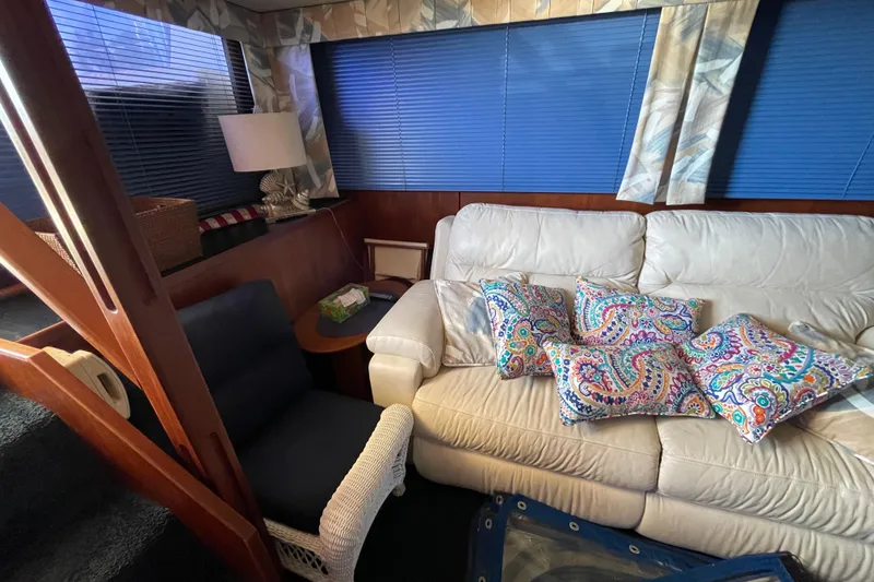 Slide: The Image of Interior of 1985 Chris-Craft 426 Catalina with white sofa and colorful cushions. - 20