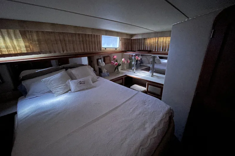 Slide: The Image of Cozy bedroom interior of 1985 Chris-Craft 426 Catalina yacht with elegant decor and soft lighting. - 26