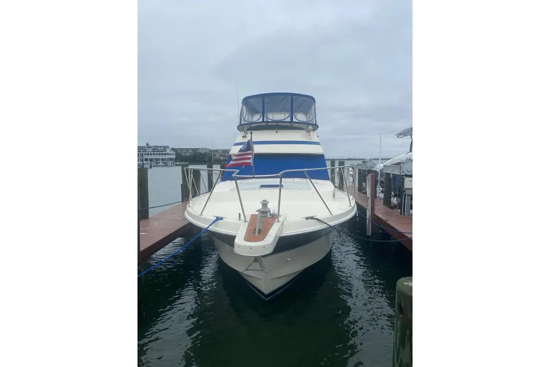 Slide: The Image of 1985 Chris-Craft 426 Catalina yacht docked in a covered marina. - 3