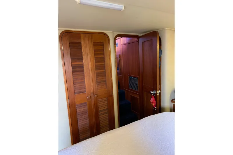 Slide: The Image of 1985 Chris-Craft 426 Catalina interior with wooden doors and cozy cabin space. - 30