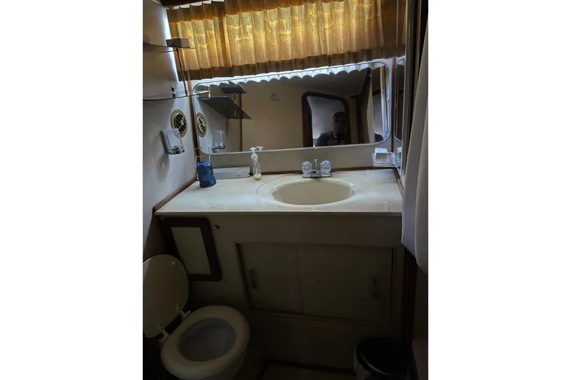 Slide: The Image of Bathroom interior of 1985 Chris-Craft 426 Catalina yacht, featuring sink and toilet. - 31