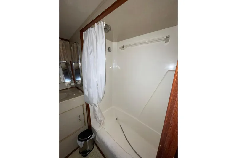 Slide: The Image of 1985 Chris-Craft 426 Catalina bathroom with shower, curtain, and vanity. - 33