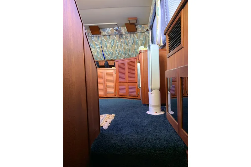 Slide: The Image of Interior of 1985 Chris-Craft 426 Catalina with wood paneling and modern fan. - 35