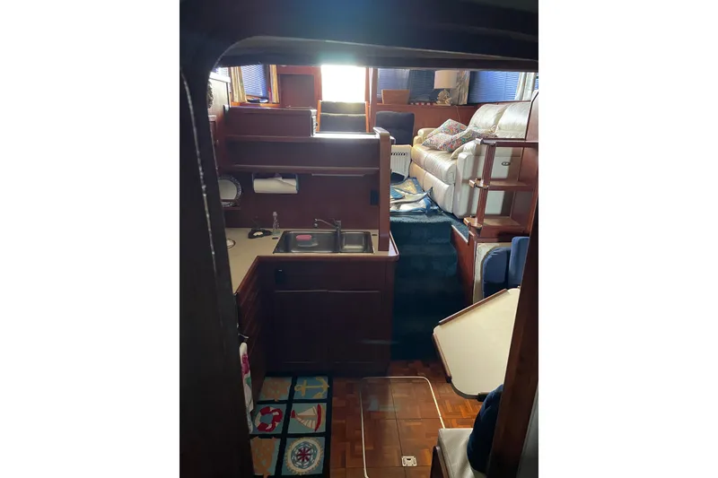 Slide: The Image of Interior of 1985 Chris-Craft 426 Catalina yacht with cozy seating and kitchenette. - 36