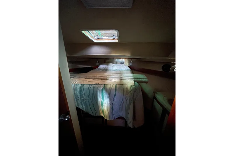 Slide: The Image of Cozy cabin interior of 1985 Chris-Craft 426 Catalina with bed and porthole window. - 40