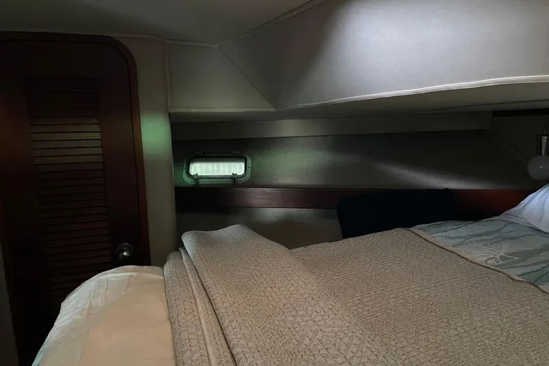 Slide: The Image of Cozy cabin interior of 1985 Chris-Craft 426 Catalina with bed and porthole window. - 43