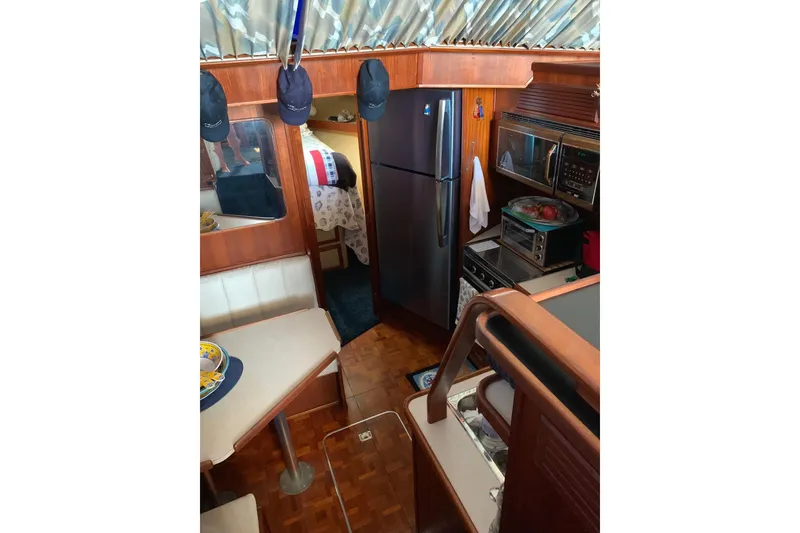 Slide: The Image of 1985 Chris-Craft 426 Catalina boat interior with seating and waterfront view. - 8