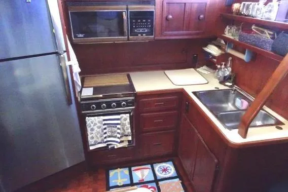 Slide: The Image of 1985 Chris-Craft 426 Catalina yacht deck with covered seating and life preserver. - 9