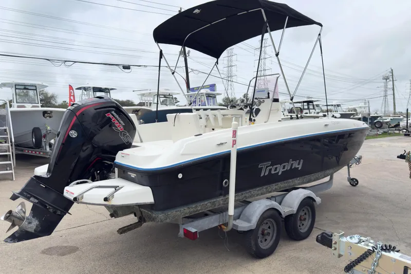 Slide: The Image of 2022 Bayliner Trophy T21Bay boat on trailer, featuring a powerful outboard motor. - 3
