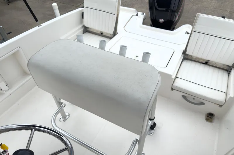 Slide: The Image of 2022 Bayliner Trophy T21Bay boat interior with seating and steering wheel. - 5
