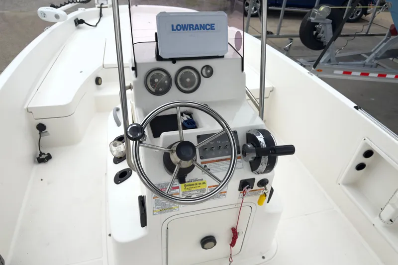 Slide: The Image of 2022 Bayliner Trophy T21Bay boat cockpit with steering wheel and control panel. - 6