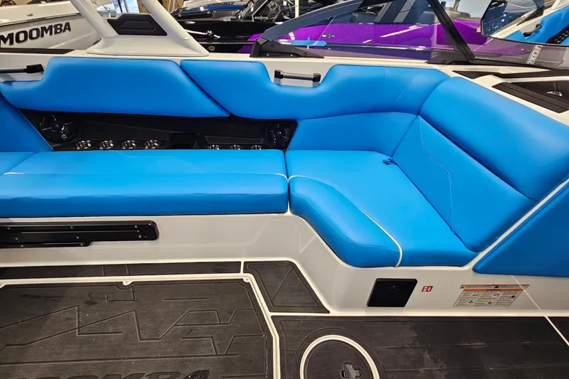 Slide: The Image of 2026 Moomba Max boat interior with vibrant blue seating and sleek design. - 12