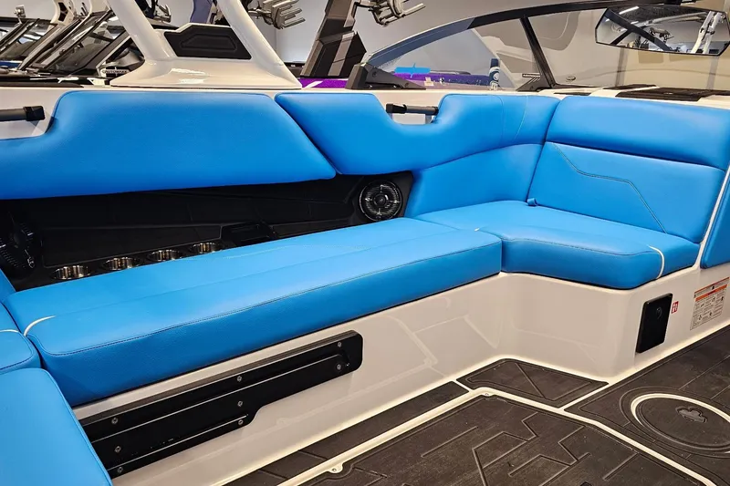 Slide: The Image of 2026 Moomba Max boat interior with blue seating and modern design. - 13