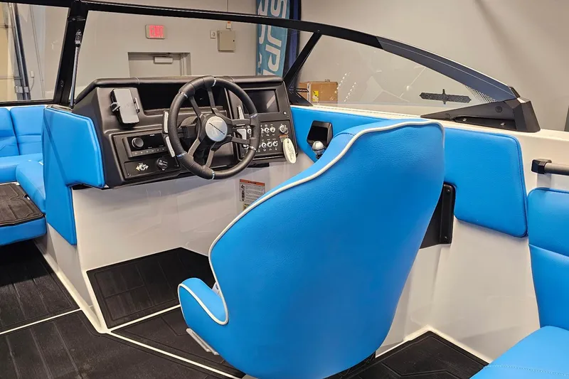 Slide: The Image of 2026 Moomba Max boat interior with blue seating and modern dashboard design. - 14